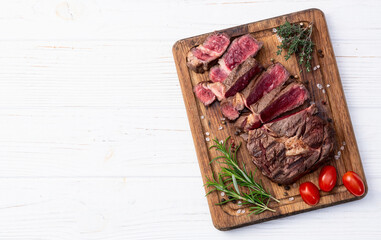 Ribeye grilled  beef steak sliced . Rare doneness photography . Top view