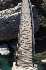 a pedestrian bridge built over a river