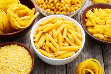 Assorted Uncooked Pasta in Bowls on Wooden Table