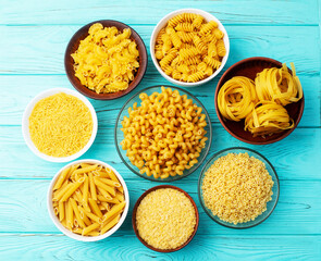 Assorted Uncooked Pasta in Bowls on Wooden Table