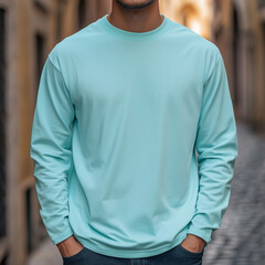 Mockup of a man wearing a blank long-sleeved turquoise T-Shirt, isolated on the background of an old city street, Ai generated images