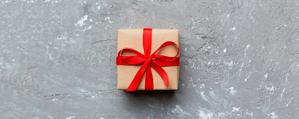 Valentine day composition: red gift box with bow and heart. Christmas present. View from above....