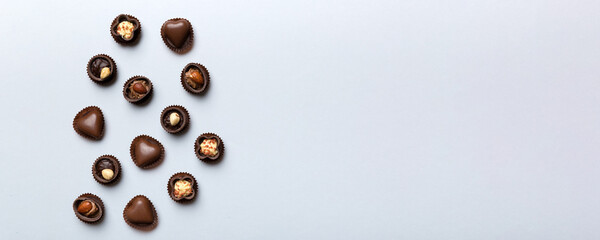 Different kinds of chocolates on colored table close-up. Top View and Flat Lay with copy space