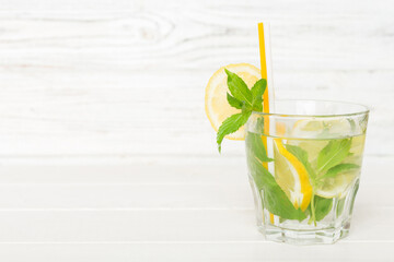 Mojito cocktail. Refreshing mojito cocktail with lime, lemon and mint in a tall glass with a stick
