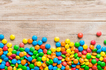 Mixed collection of colorful candy, on colored background. Flat lay, top view. frame of colorful chocolate coated candy