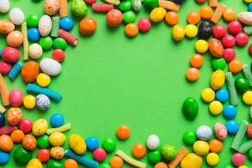 Mixed collection of colorful candy, on colored background. Flat lay, top view. frame of colorful chocolate coated candy
