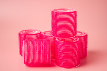 Pink Velcro rollers on a pink background