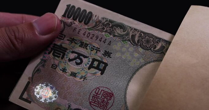 A footage of taking Japanese old bills out of an envelope