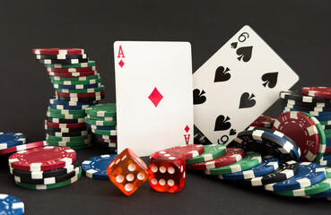  red dice, cards and poker chips, on a black background 