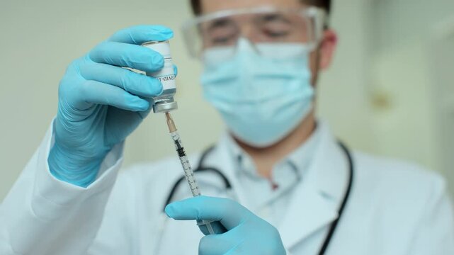 Doctor, nurse, scientist, researcher hand holding new coronavirus vaccine for human clinical trials.