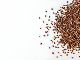 Naklejka premium brown grains spilling from a pile, minimalist design, white background