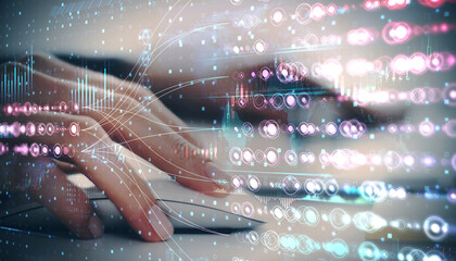 Abstract depiction of a hand typing on a keyboard with overlay of holographic digital data.