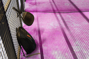  bag with tennis padel racket and ball on grassy field at tennis court, copy space. Unaltered, sport, competition, green, nature and summer concept.