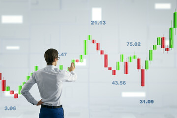 Businessperson analyzing green and red candlestick chart on light background.