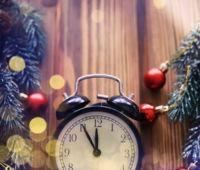Christmas gifts, fir branches and alarm clock on wooden table. Boxing day