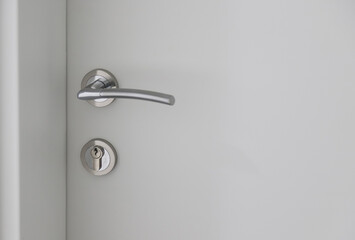Modern door handle adorned with sleek chrome finish offering a contemporary touch to interior design in an urban environment