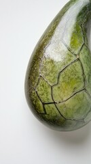 Naklejka premium Intricate Green Ceramic Sculpture - An Exquisite Oval Vessel with a Distinctive Pattern