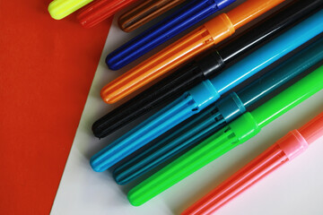 Colorful Crayons and flomasters on paper background stock photo
