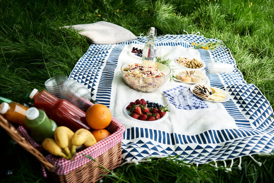 Healthy picnic snacks on a blanket in grass