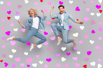 Full size photo of hooray couple jump wear jeans shirt shoes isolated on grey color background