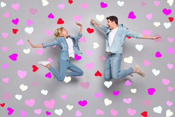 Full length body size view of attractive cheerful couple jumping having fun pastime isolated over...