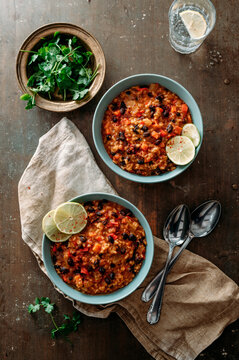 Spicy Creole stew with black beans and rice served in bowls