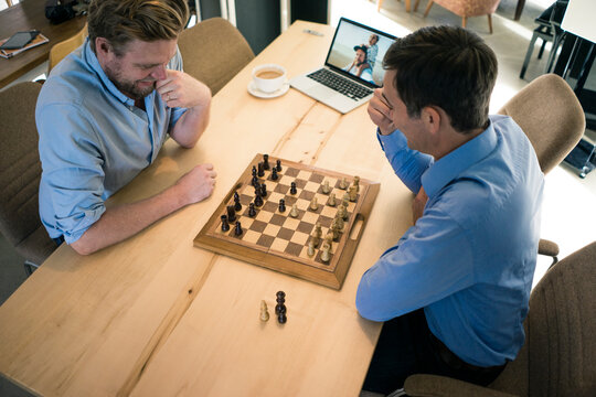 Top view of two men playing chess