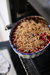 Close-up of a homemade fruit crumble with a golden, crispy streusel topping