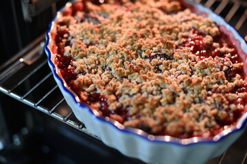 Close-up of a homemade fruit crumble with a golden, crispy streusel topping
