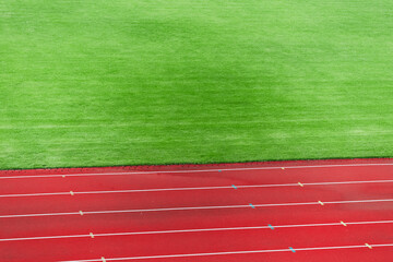 sport space athletic running track and football field complex background vivid colors green and red...