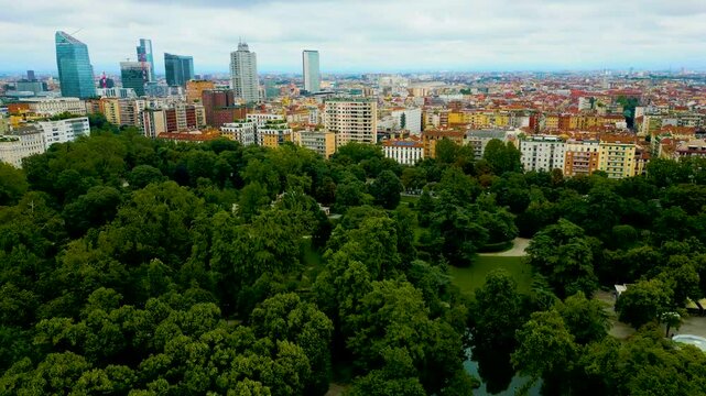 4K Aerial Drone Video of High Rise Apartment Buildings and Modern Skyscrapers near Indro Montanelli Garden Park in Milan, Italy on a Summer Day