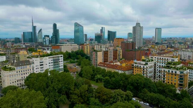 4K Aerial Drone Video of High Rise Buildings on the Edge of Indro Montanelli Garden Park in Downtown Milan, Italy on a Summer Day