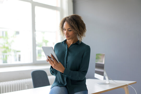 Young businesswoman using digital tablet in office