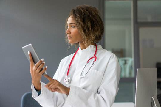 Portrait of young doctor with stethoscope and digital tablet