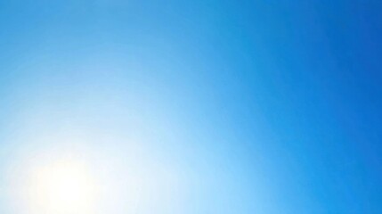 Obraz premium A bright blue sky fills the frame, illuminated by soft sunlight, creating a serene atmosphere