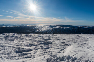 Obraz premium Petrovy kameny, Vysoka hole and lower hills on the background from Praded hill summit in winter Jeseniky mountains