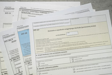 Obraz premium PIT-36 PIT-37 PIT-38 Annual tax return polish pit forms with pen on table