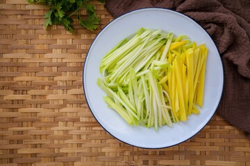 Sliced ​​mango on a  white plate prepare for cooking, raw mango