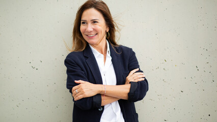 Portrait cheerful woman dressed in a blazer and white shirt