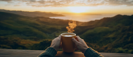 Golden Hour Coffee:  A steaming cup of coffee held in the hands of a person, capturing a breathtaking panoramic vista of a sun-kissed mountain landscape as the golden rays of sunrise paint the sky.  