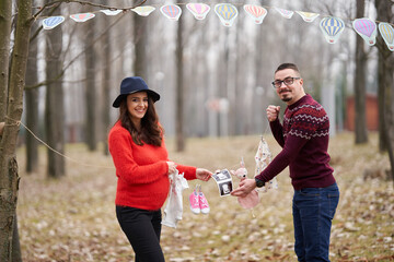 Couple announcing pregnancy outdoors