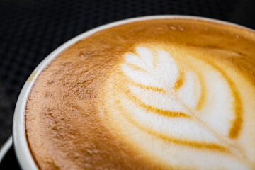 macro close up coffee cappuccino latte art crema cappucinno in ceramic cup mug