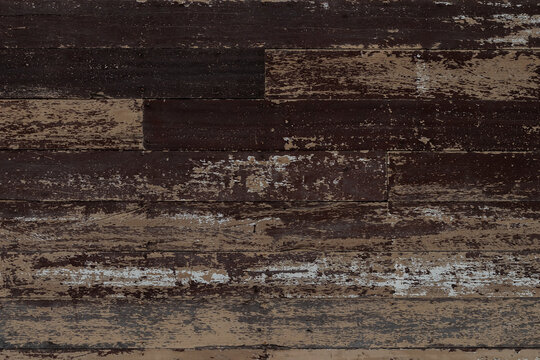Image of vintage hardwood board with rough surface. Pattern and textured from old plank wooden wall with dark brown scratch coloring background.