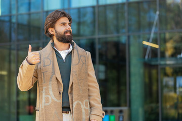 Like. Happy business man raises thumb up agrees with something or gives positive reply recommends...