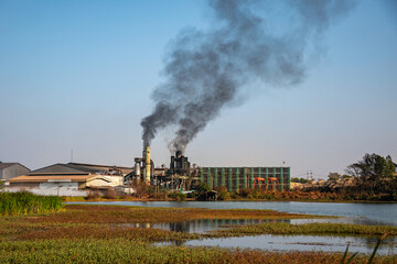 Smokestacks of factories emitting carbon pollution into the sky causing climate change,...