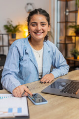 Indian freelancer accountant working with financial graph documents, calculate taxes for charts and...