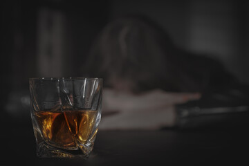 Alcohol addiction. Drunk woman, focus on glass of whiskey