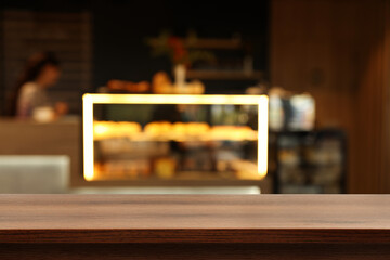 Empty wooden table in stylish cafe. Space for design