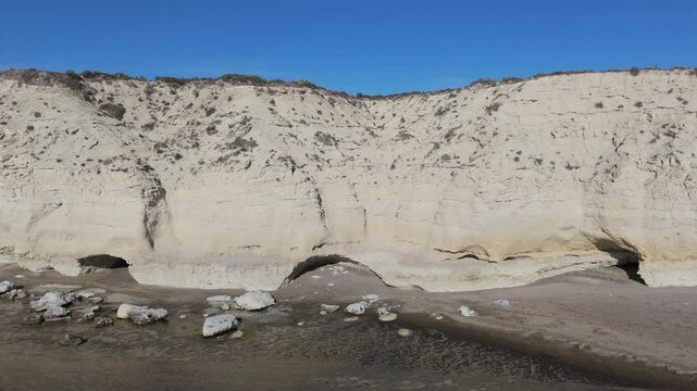 Aerial and frontal shot of El ca&ntilde;ad&oacute;n de las Ostras on the Argentinean sea coast receiving the morning sun on a clear day