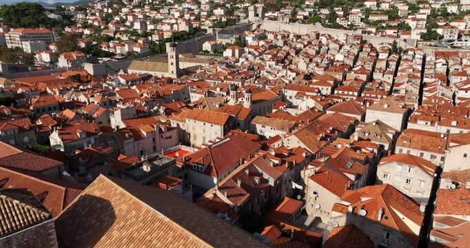 Backward aerial over Dubrovnik Old Town reveals Saint Blaise Church facade, Croatia.